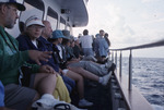 A row of Florida Ornithological Society (FOS) members wait on deck during a pelagic birding trip in West Palm Beach
