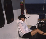 A Florida Ornithological Society (FOS) member sits in thought during a pelagic birding trip in West Palm Beach