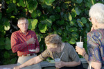 Three Florida Ornithological Society (FOS) members tend to their plates and drinks while mid-conversation during the 1995 fall meeting in Cocoa Beach