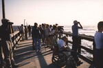 A crowd of Florida Ornithological Society (FOS) members line a pier in Jacksonville, Florida while observing seabirds