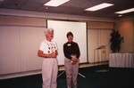 Two Florida Ornithological Society members stand at the front of a Holiday Inn conference room during a meeting in Jacksonville, Florida
