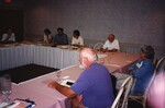 John Douglas, Ted Below, and other Florida Ornithological Society members line a rectangle of conference tables during a meeting in Jacksonville, Florida