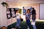 Birders study informational posters at a Florida Ornithological Society meeting in Jacksonville, Florida