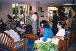 A dozen Florida Ornithological Society members lounge on loveseats and chat during a meeting in Jacksonville, Florida