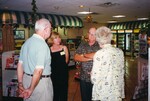 Glenn Woolfenden stands conversing with three other Florida Ornithological Society members in a small convenience store in Jacksonville, Florida