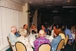 Glenn Woolfenden chats at a dinner table with nine others during a Florida Ornithological Society meeting in Jacksonville, Florida