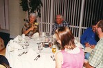 Peggy Powell sits at a round dinner table with five other Florida Ornithological Society members at a meeting in Jacksonville, Florida
