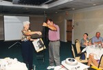 Peggy Powell directs someone holding a groundpost while presenting at a Florida Ornithological Society meeting in Jacksonville, Florida