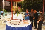 Four guests stand beside a table of food and plates during a Florida Ornithological Society meeting in Tampa, Florida