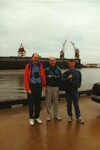 Peter Merritt, Frank Lohrer, and Todd Engstrom smile for a photo in front of the Port of Tampa