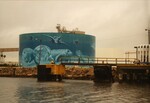 A Citgo gas reservoir painted with an underwater portrait of manateees and other sea creatures sits across the water at the Port of Tampa