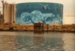 A Citgo gas reservoir stands painted with an underwater portrait of manateees and other sea creatures at the Port of Tampa