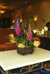 A colorful floral arrangement serves as a coffee table centerpiece at the Holiday Inn Busch Gardens in Tampa, FL