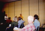 Two presenters face a seated audience during a Florida Ornithological Society meeting in Tampa, Florida