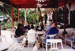 Dave Goodwin, Jan Woolfenden, and Ted Below chat with four others on an outdoor patio in Tampa, Florida