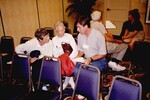 Three seated Florida Ornithological Society members consult a stack of documents during a meeting in Tampa, Florida