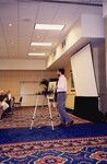 A Florida Ornithological Society member presents in front of a blank projector screen during a spring meeting in Tampa, Florida