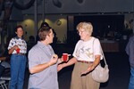 Two guests mingle while Linda Cooper looks on during a Florida Ornithological Society meeting in Tampa, Florida