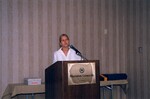 A presenter in a white blouse speaks during a Florida Ornithological Society meeting in Gainesville, Florida