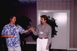 Andy Kratter passes a video cassette to a fellow guest at a Florida Ornithological Society meeting in Gainesville, Florida