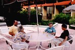 Guests chat at a covered outdoor table during a Florida Ornithological Society meeting in Gainesville, Florida by Florida Ornithological Society