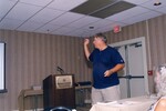 A speaker gestures with his glasses while presenting at a Florida Ornithological Society meeting in Gainesville, Florida