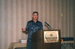 A speaker with a presentation remote speaks at a podium at a Florida Ornithological Society meeting in Gainesville, Florida