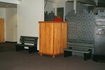 A large wooden crate sits between two benches at the Florida Museum of Natural History