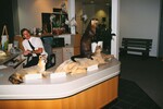 A man sits behind a reception desk featuring taxidermied animals at the Florida Museum of Natural History