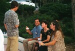 Four guests chat outside during a Florida Ornithological Society meeting in Gainesville, Florida