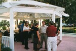 Pam Bowen mingles with other guests beside a gazebo bar during a Florida Ornithological Society meeting in Gainesville, Florida by Florida Ornithological Society