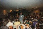 Bruce Hallett addresses a sea of seated Florida Ornithological Society members from the center of the room