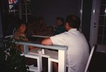 Linda Douglas smiles at the camera while sitting with another Florida Ornithological Society member in the Bahamas