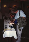 Wes Briggs and Bruce Hallett discuss and observe bird skins at a meeting in the Bahamas by Florida Ornithological Society