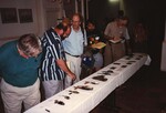 Wes Biggs, Eugene Stoccardo, and Fred Lohrer discuss and study bird skins at a meeting in the Bahamas by Florida Ornithological Society
