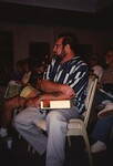 Wes Biggs sits with a tray of Kodak slides in his lap during a Florida Ornithological Society meeting by Florida Ornithological Society