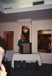 A Florida Ornithological Society member in a striped polo presents to an audience during a meeting in the Bahamas by Florida Ornithological Society