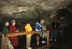 Eugene Stoccardo, Pat Anderson, and other Florida Ornithological Society members in ponchos observe the inside of Owl's Hole in the Bahamas