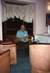 A Florida Ornithological Society member snacks from a leather armchair during the 1996 meeting in the Bahamas