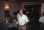 A Florida Ornithological Society member poses with a bottled drink and a cup at the 1996 meeting in the Bahamas