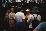 Pat Anderson, Mary Davidson, and Lyn Atherton chat by the treeline during a Florida Ornithological Society birding trip in the Bahamas