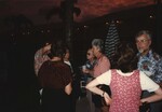 Groups of FOS members mingle on a poolside deck at the 1996 meeting in the Bahamas