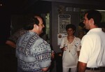 Four Florida Ornithological Society members chat on a poolside deck during the 1996 fall meeting in the Bahamas by Florida Ornithological Society