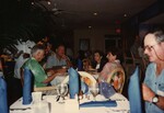 Four Florida Ornithological Society members chat at a round dining table during the 1996 meeting in the Bahamas