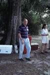 Glen Woolfenden walks past a set of drink coolers during a picnic at Archbold Biological Station
