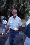 Ted Below holds a bowl of food during a picnic at Archbold Biological Station