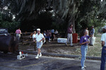 Florida Ornithological Society (FOS) members picnic beside a parking lot under the trees at Archbold Biological Station