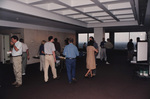 A conference room of guests mingle and eat snacks during a Florida Ornithological Society meeting in Tallahassee, Florida