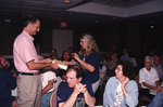Jim Cox presents Judy Bryan with a book during a Florida Ornithological Society meeting in Tallahassee, Florida by Florida Ornithological Society