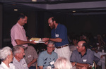Jim Cox presents George Wallace with a book during a Florida Ornithological Society meeting in Tallahassee, Florida by Florida Ornithological Society